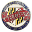 Crawford Radiator Emblem. - Colorful circular, metal emblem this is 2.25” diameter. Red banner with silver “Crawford” in script across middle, over a multi-color badge. White background in middle, blue edge with “Crawford Automobile Co., Hagerstown, MD, USA” on it.