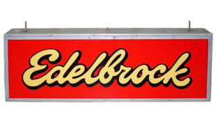 Edelbrock Large Lighted Plastic Dealership Sign. Large, rectangular sign. Red with “Edelbrock” written in cursive yellow letters which turn white when the sign lights up.