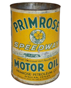 Primrose Speedway Metal 5 Quart Oil Can. Yellow can with some wear and rust. “PRIMROSE MOTOR OIL” is written across the can in large green letters. A primrose graphic is featured in the center with “SPEEDWAY” written underneath. “PRIMROSE PETROLEUM CO.” and “DALLAS, TEXAS” are written small black letters across the bottom.