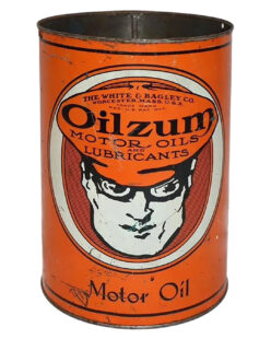 Oilzum Metal 5 Quart Oil Can. Orange can with some wear and discoloration. “THE WHITE & BAGLEY CO” and “WORCESTER, MASS. USE” is written in tiny black letters on the top. “OILZUM MOTOR OILS & LUBRICANTS” is written in large black letters below in the center followed by a white and black goggle-eyed man graphic. “Motor Oil” is written in small black letters on the bottom.