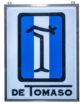 1970s Original De Tomaso Lighted Sign, 48.5”x37”. Metal framed with hanging holes at top. Single-sided white plastic background with blue/white striped De Tomaso large in middle, and the word, De Tomaso at the bottom.