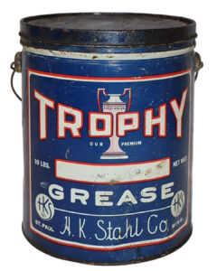 Trophy 10 Pound Grease Can. Blue can with black top. Some wear and discoloration. “TROPHY’ is written across the top in large red and white letters over a trophy graphic. “GREASE” is written below in white letters with “H.K. Stahl Co” and “St. Paul Minnesota” written across the bottom.