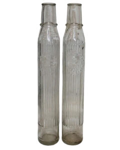 Group of 2 Tiolene Tall Glass Embossed 1 Quart Bulk Oil Bottles. Two tall, slender, clear glass bottles with “Tiolene Motor Oil” embossed across the center.