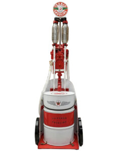 1920s Arbox “Texaco” French Fuel Dispenser. 108” tall. Red and white colors. Fuel pump has been mounted to a steel spoked wheel portable chariot-inspired cart with a 55-gallon drum barrel locked into bottom. Great graphics presented with Texaco Aviation livery.