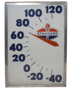 Standard Oil Advertising Thermometer. Rectangular thermometer in a silver frame. White sign with blue numbers with 120 at the top, descending by 120 to –40 at the bottom. The red and blue Standard Oil logo with a torch is featured under the numbers.